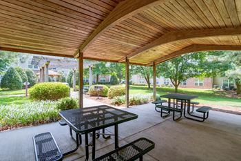 A wooden patio with a table and chairs